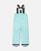 Close-up of Cordura® reinforced knees on turquoise snowsuit pants – durable winter gear
