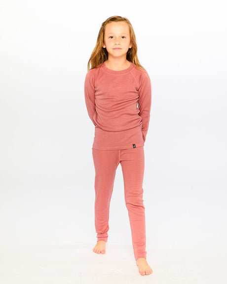 Child wearing the Deux par Deux dusty pink merino wool base layer set, view 4
