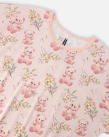 Close-up of the peach trimmed crew neck and teddy bear print on the PJ top