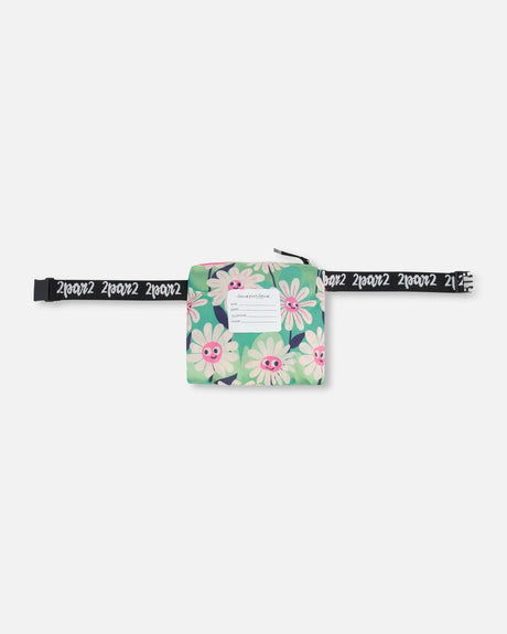 Green flower windbreaker packed into its pouch on a black logo belt strap