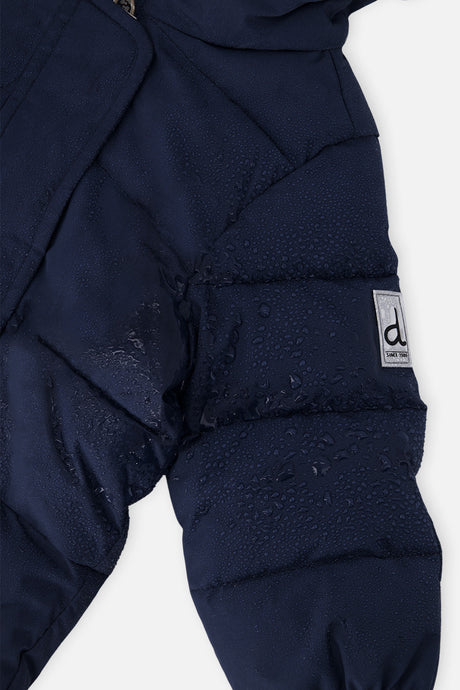 Close-up of the dark blue quilted shoulder and logo tab on the Baby Cloud snowsuit