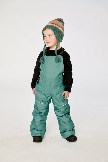 Child wearing the Deux par Deux DISCOVER snowsuit, beige with dog print, lookbook view