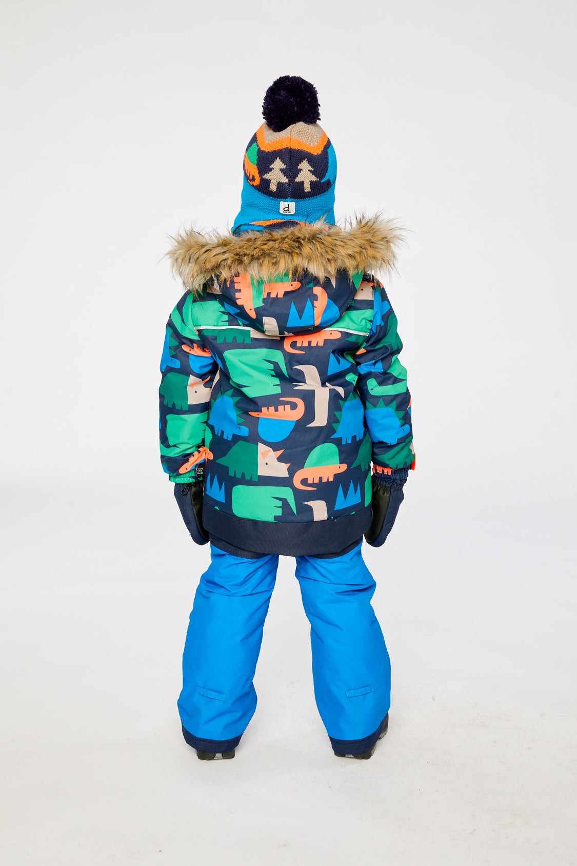 Child wearing the Deux par Deux DISCOVER snowsuit in Blue Dinosaur Print, lookbook view