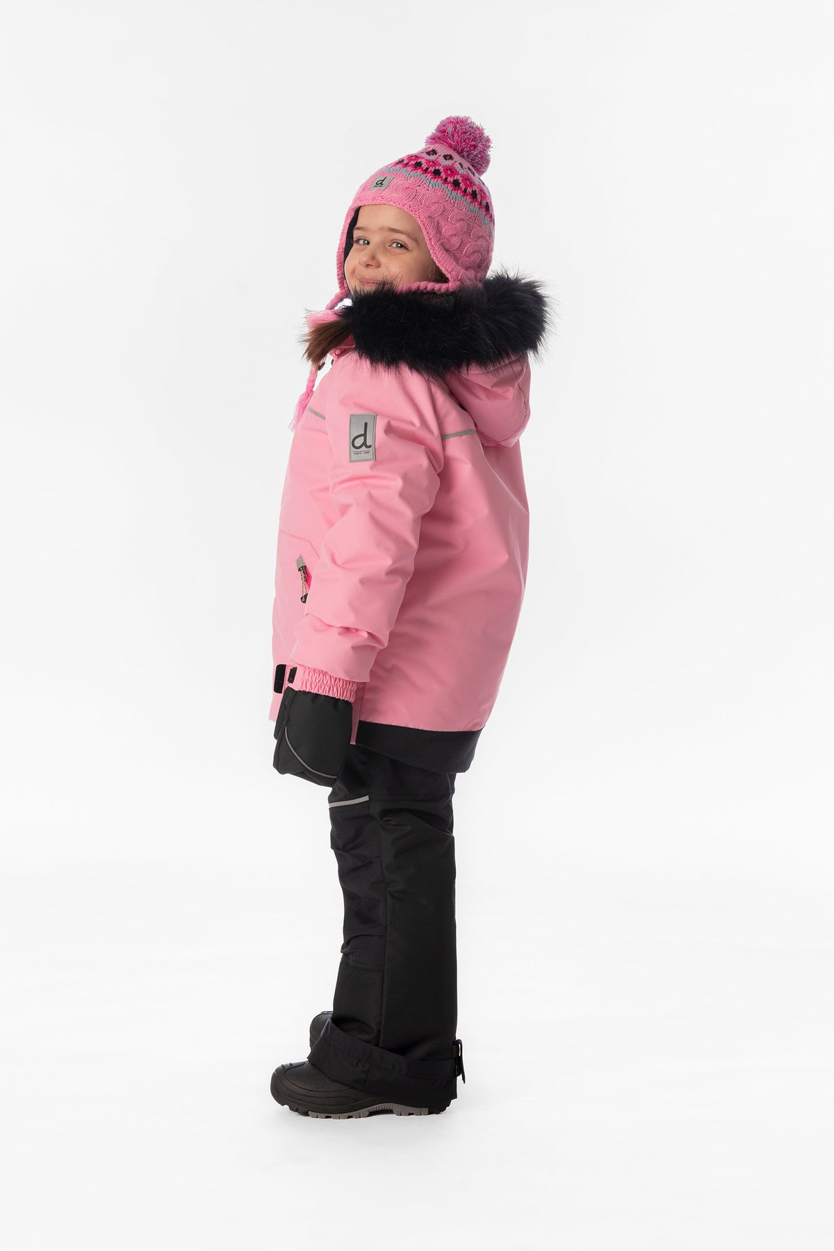 Child wearing the pink Deux par Deux DISCOVER snowsuit, lookbook view 2