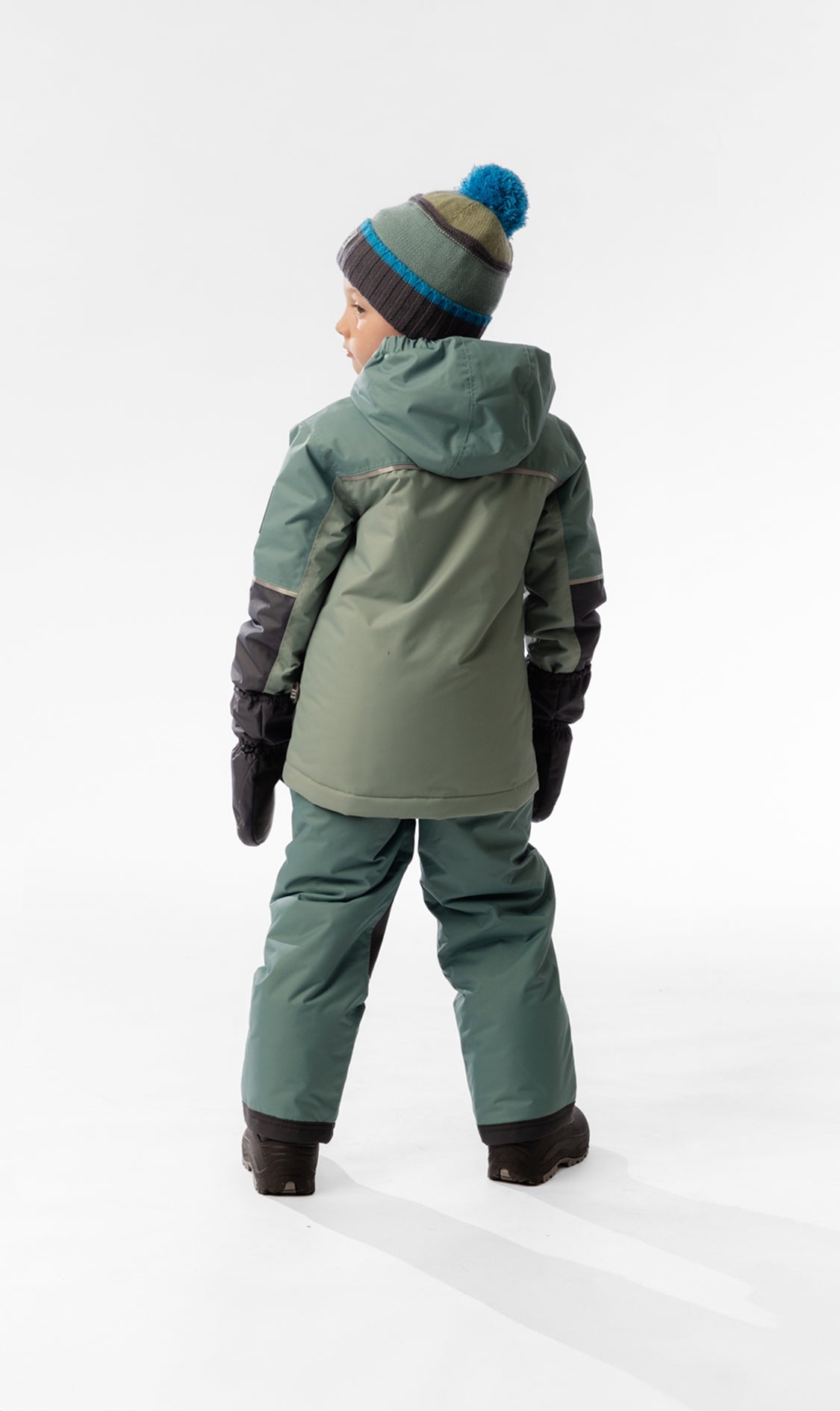 Child wearing the Deux par Deux CHILL lightweight snowsuit in Sage Green, lookbook view