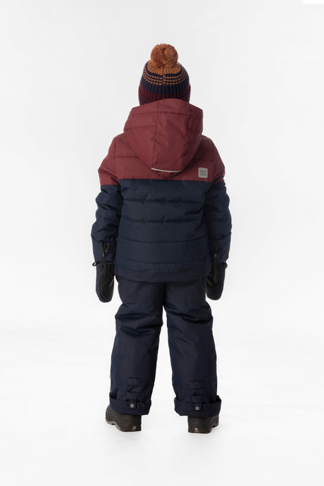 Child wearing the Deux par Deux PLAY snowsuit in navy and burgundy, lookbook view 3