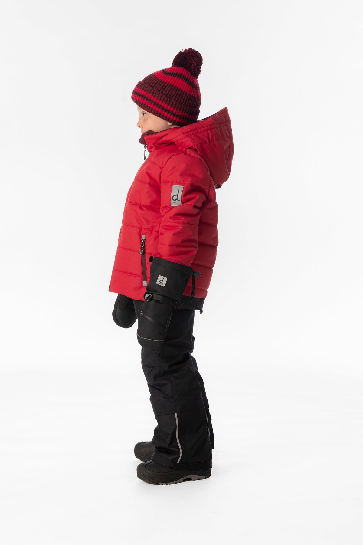 Child wearing the Deux par Deux PLAY snowsuit in red with black pants, lookbook view 2