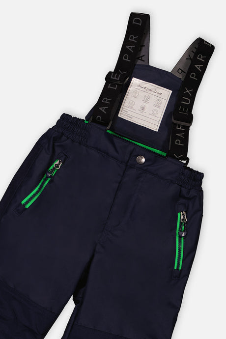 Close-up of the navy PLAY snow pants waist, zip pockets and logo suspenders