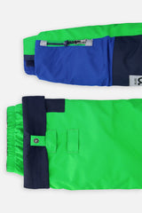 Close-up of the PLAY jacket sleeve ski-pass pocket and the adjustable green pant hem