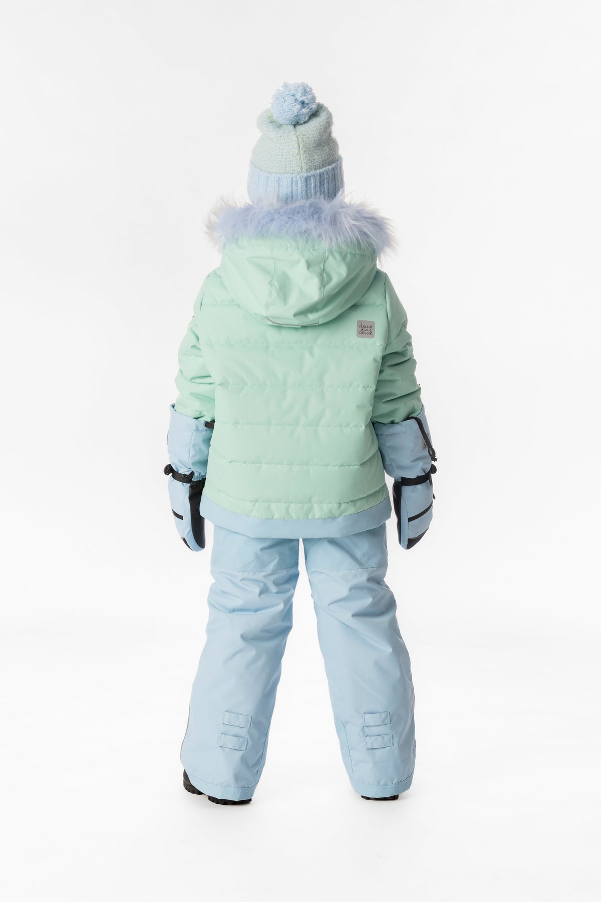 Child wearing the mint green Deux par Deux PLAY snowsuit, lookbook view 3