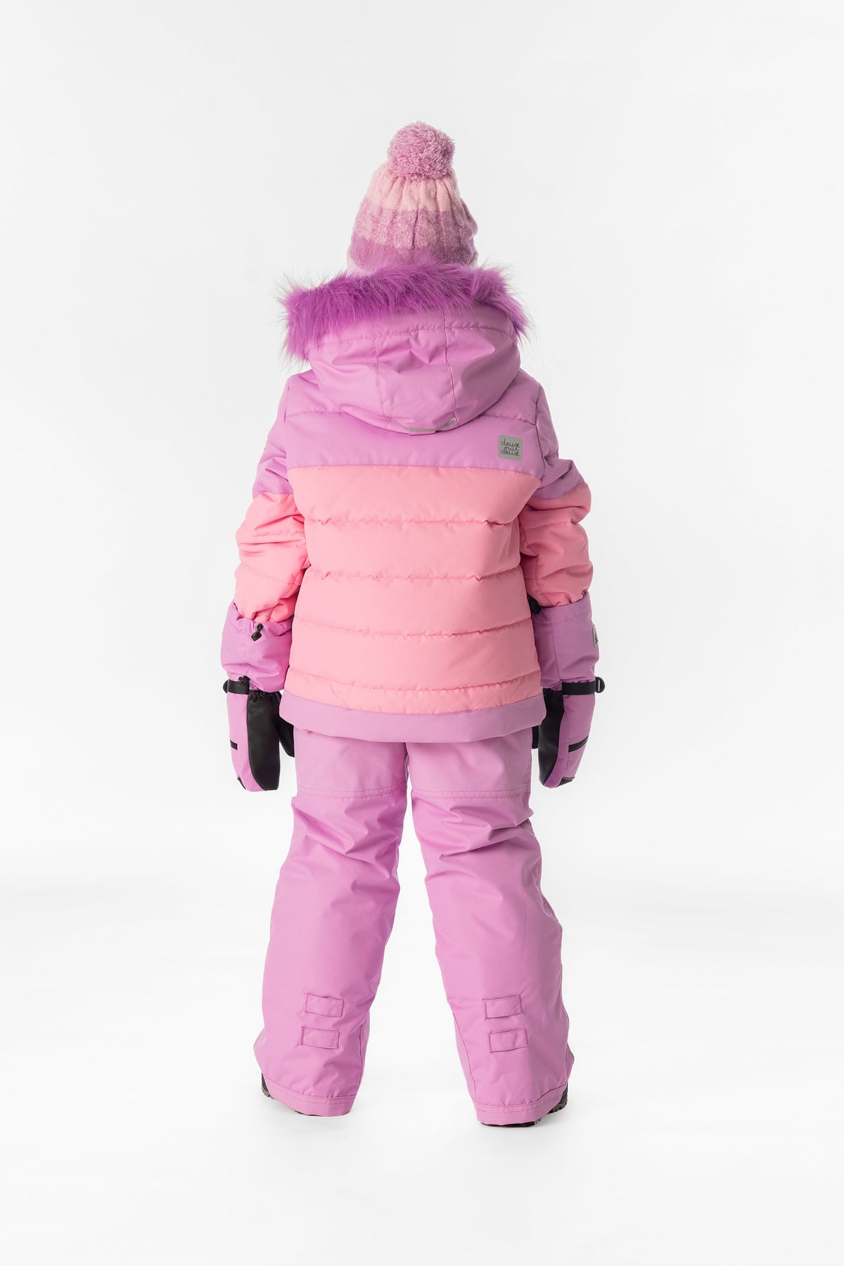 Child wearing the pinkish violet Deux par Deux PLAY snowsuit, lookbook view 3