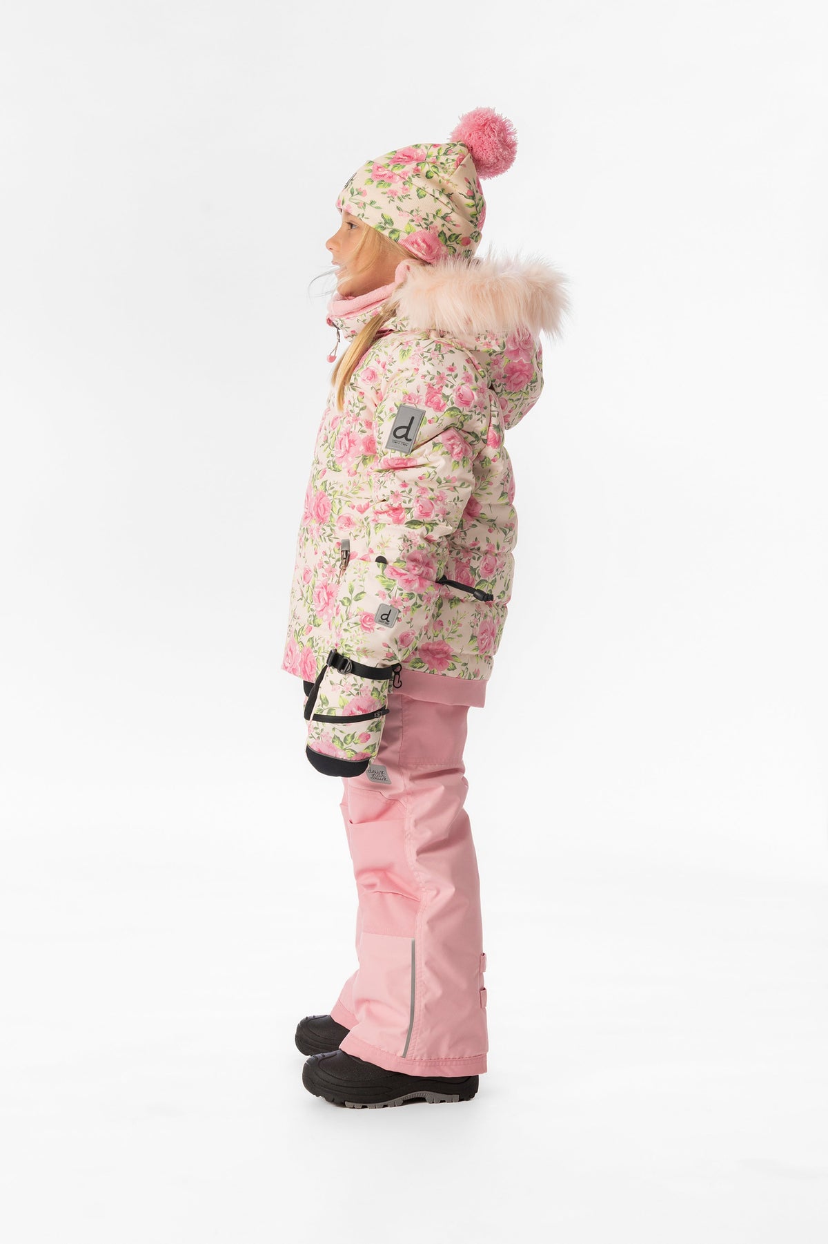 Child wearing the Deux par Deux PLAY snowsuit in pink mini flower print, lookbook view 2