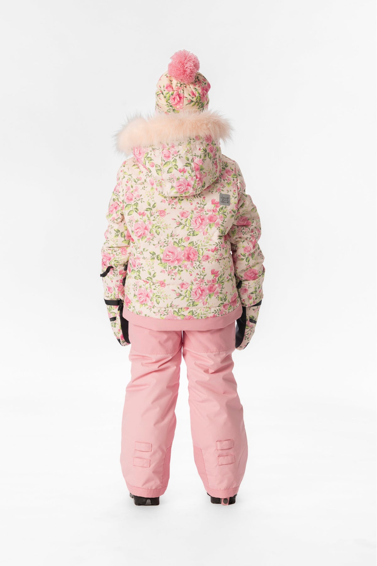 Child wearing the Deux par Deux PLAY snowsuit in pink mini flower print, lookbook view 3