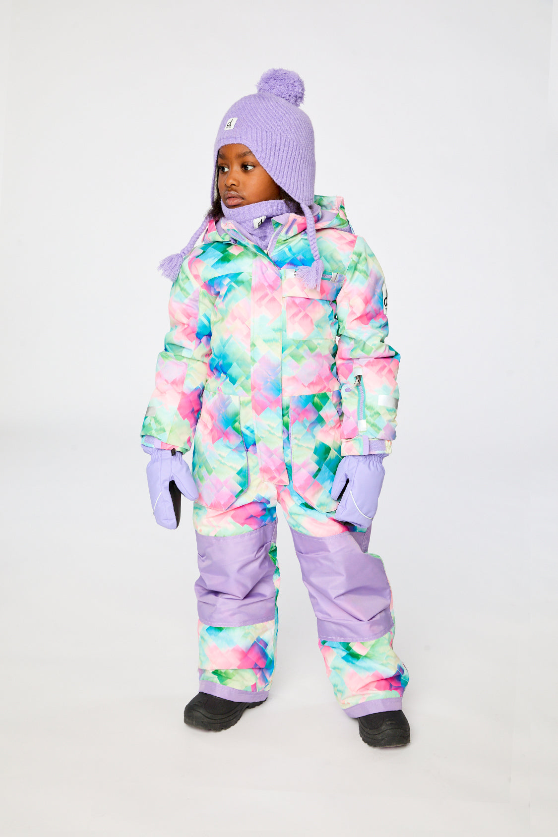 Child wearing the Deux par Deux multicolor diamond print PLAY snowsuit, lookbook view