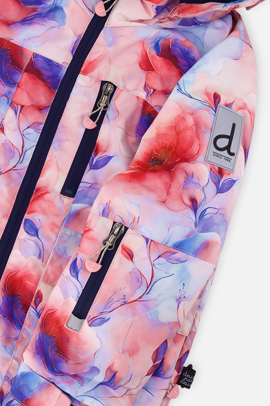 Close-up of the mauve floral PLAY jacket zipper, chest pocket and sleeve logo patch