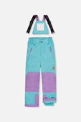 Deux par Deux girls' PLAY snowsuit with diamond-print jacket and turquoise and purple pants, another studio view