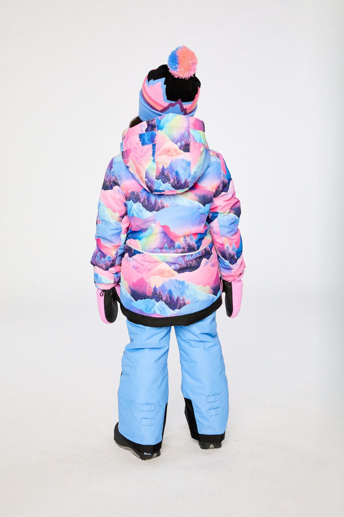Child in the pink mountain-print and blue PLAY two-piece snowsuit, third lookbook shot