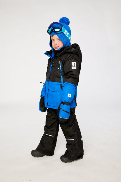 Lookbook view of a child in the royal blue and red Deux par Deux TEKNIK jacket and snow pants