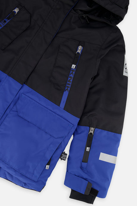 Deux par Deux boys' TEKNIK two-piece snowsuit in royal blue and red, additional studio angle