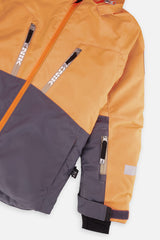 Close-up of the chest zip pockets and sleeve on the orange and grey TEKNIK jacket