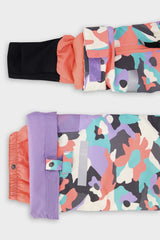 Deux par Deux girls' Teknik two-piece snowsuit in coral camouflage print with lilac panels – sleeve cuff and pant hem details