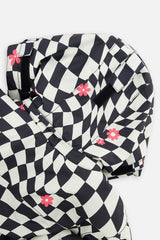 Deux par Deux girls' TEKNIK two-piece snowsuit in white and bright pink checkered print, further studio view