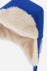 Close-up of the cream plush ear flap and blue polyester shell on the Deux par Deux lined chapka