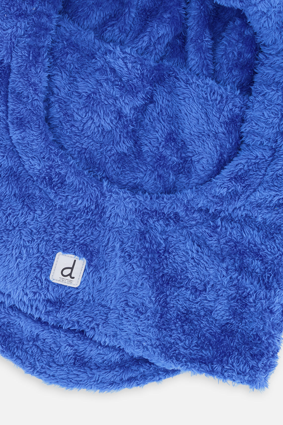 Close-up of the fuzzy blue fleece and white d logo label on the kids balaclava neck