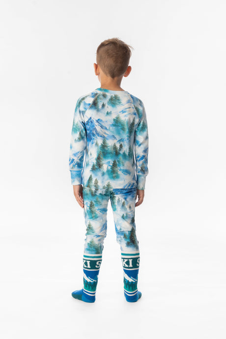 Child wearing the blue mountain print thermal base layer set, back view
