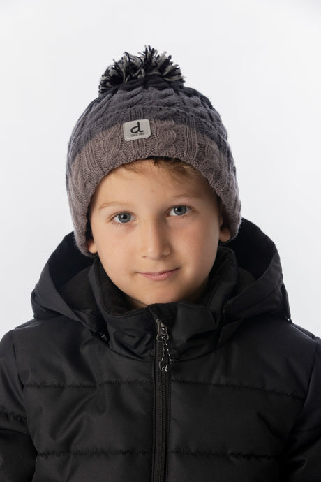 Deux par Deux kids' cable-knit pompom hat, black and grey colour block – worn by a child