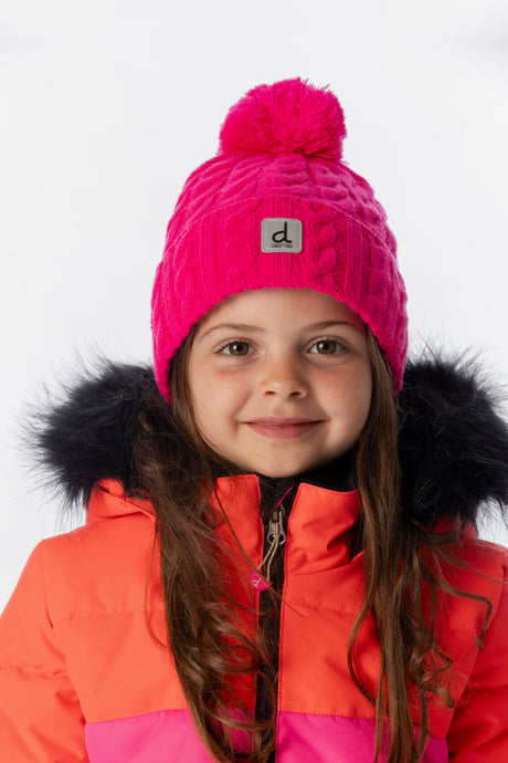 Deux par Deux kids' cable-knit pompom hat in bright pink – worn by a child