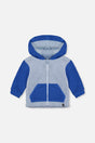 Two-tone blue sherpa hooded jacket for baby boys by Deux par Deux, front view with kangaroo pocket