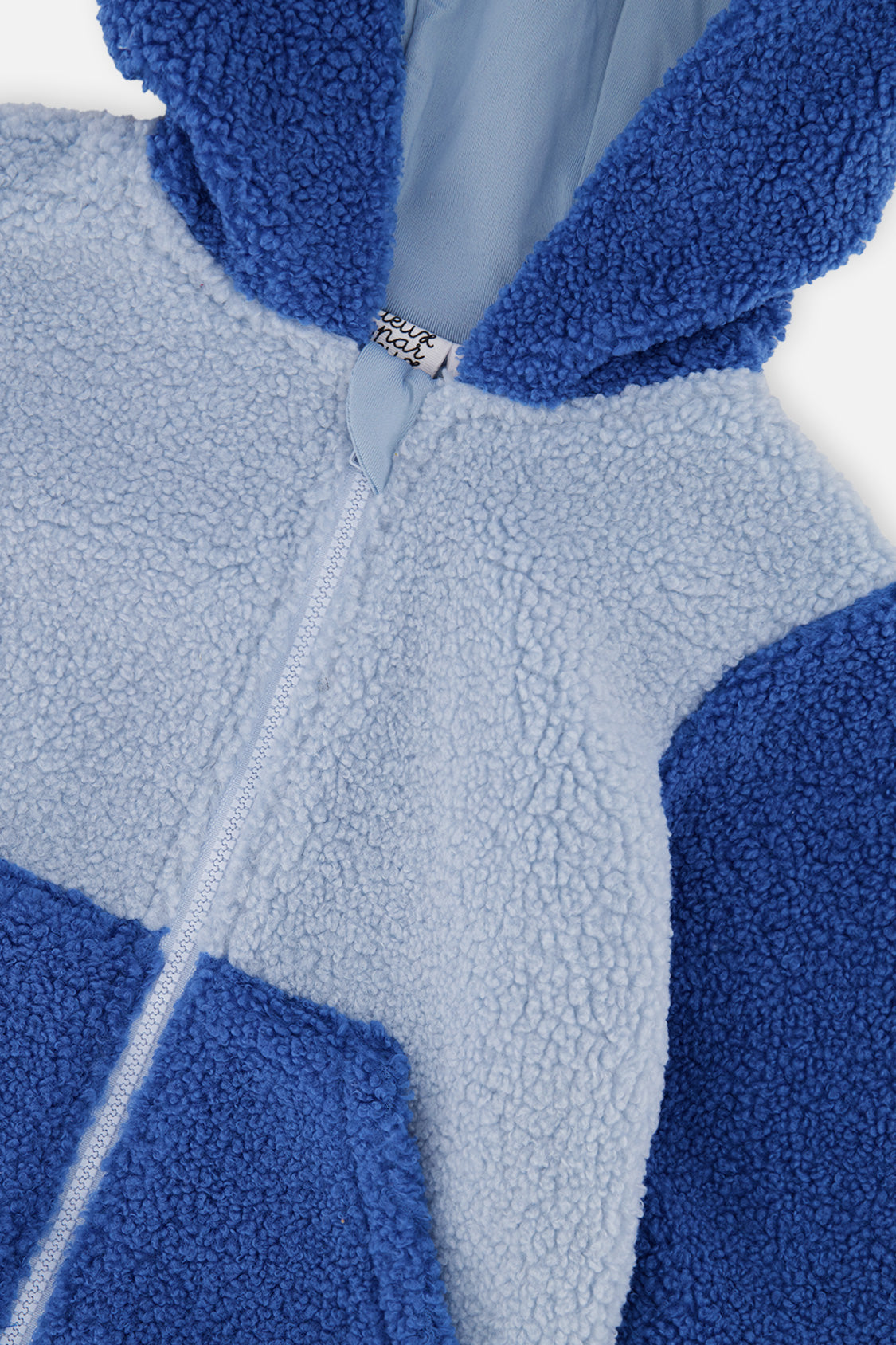 Close-up of the sherpa texture, zipper and hood on the Deux par Deux two-tone blue baby jacket