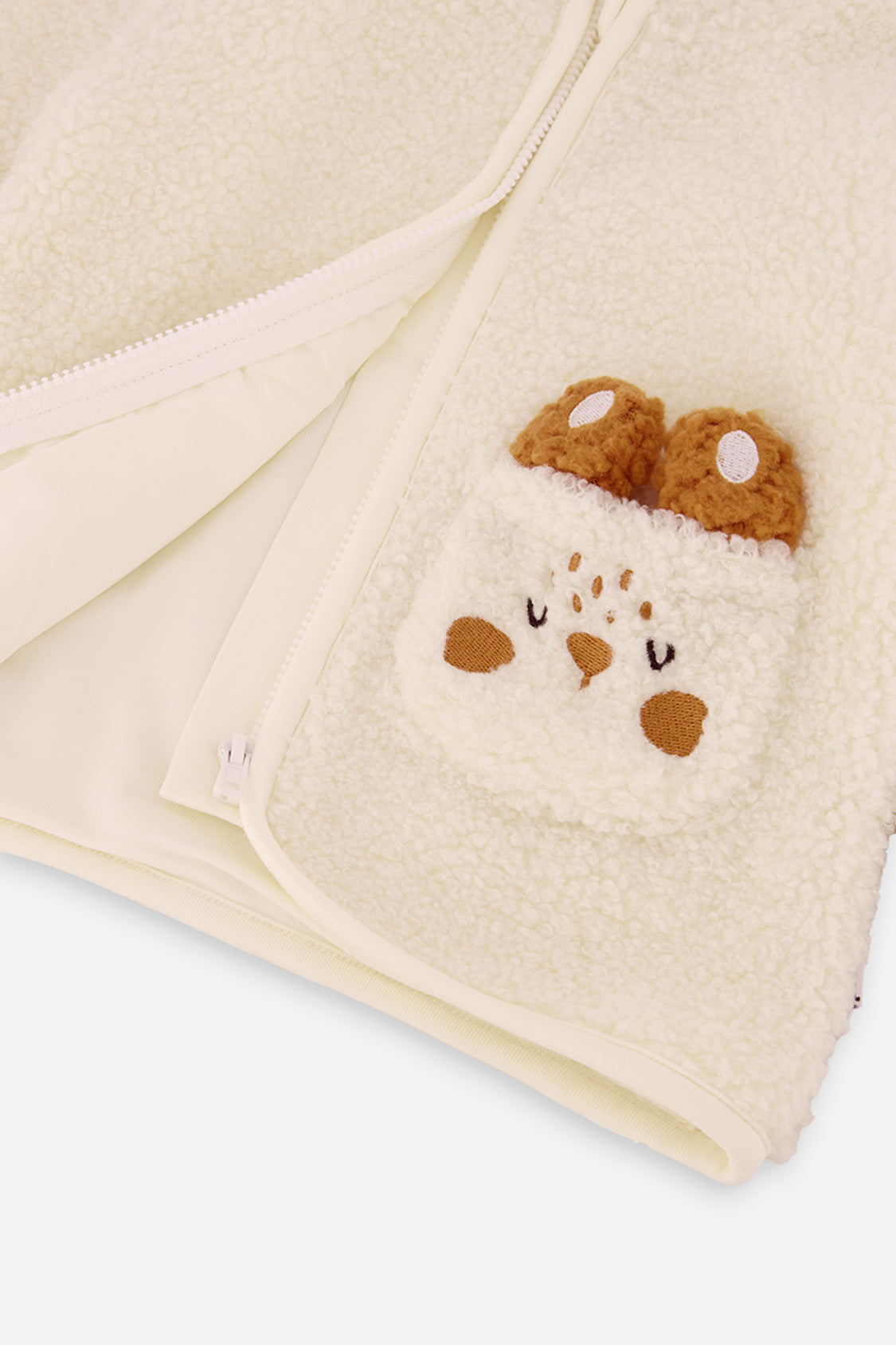Unzipped off-white Deux par Deux baby sherpa jacket showing the inside and the bunny pocket with soft ears