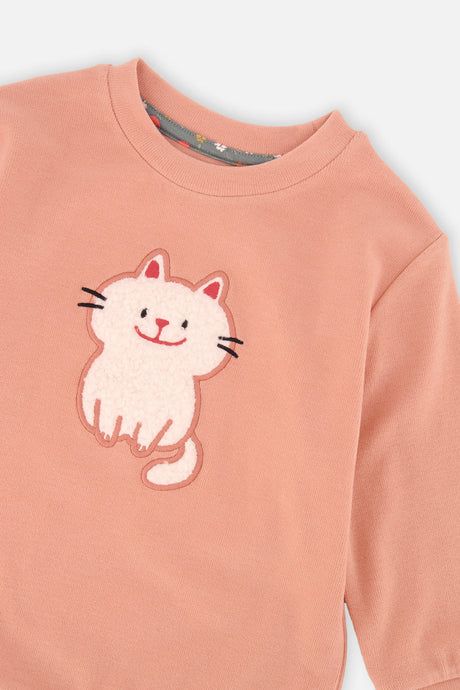 Close-up of the fluffy white cat patch on the Deux par Deux coral ribbed tunic