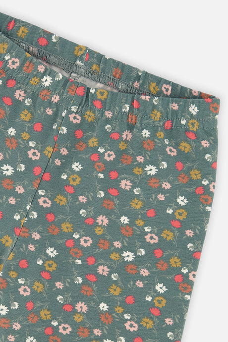 Close-up of the elastic waistband and ditsy floral print on sage green leggings