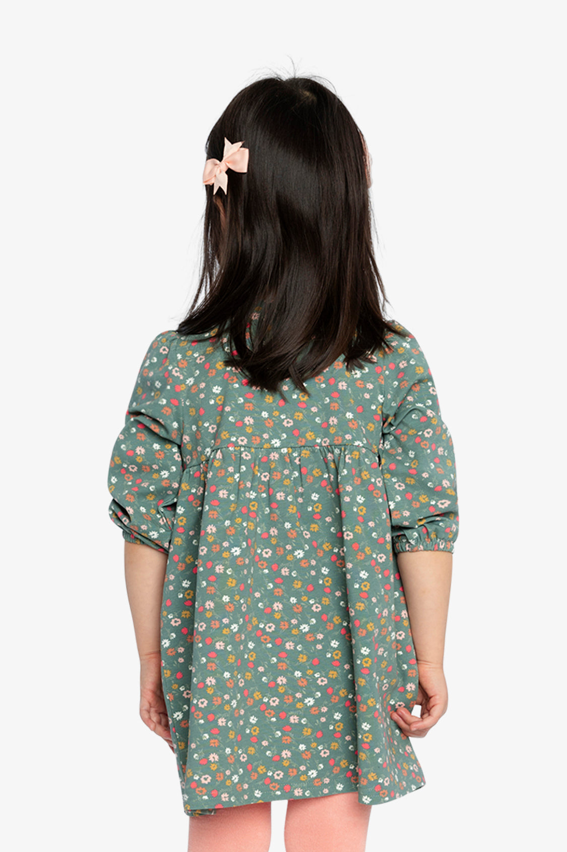 Child wearing the Deux par Deux green floral dress, back view