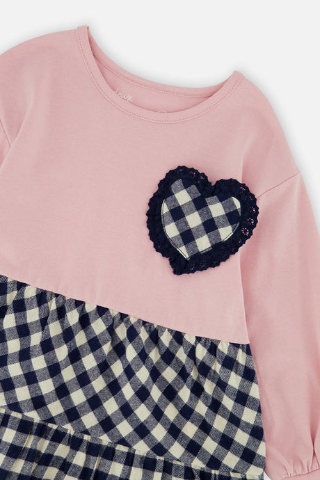 Close-up of the lace-edged gingham heart pocket on the Deux par Deux pink tunic