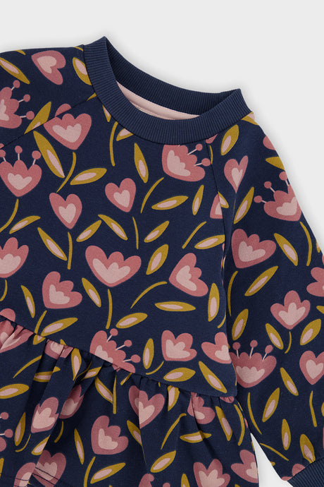Close-up of the ribbed collar and the pink tulips on the deep blue Deux par Deux peplum top