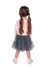Child wearing the Deux par Deux pale pink dress with a gingham mesh skirt, back view