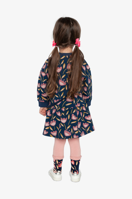 Child wearing the Deux par Deux navy tulip print dress, back view