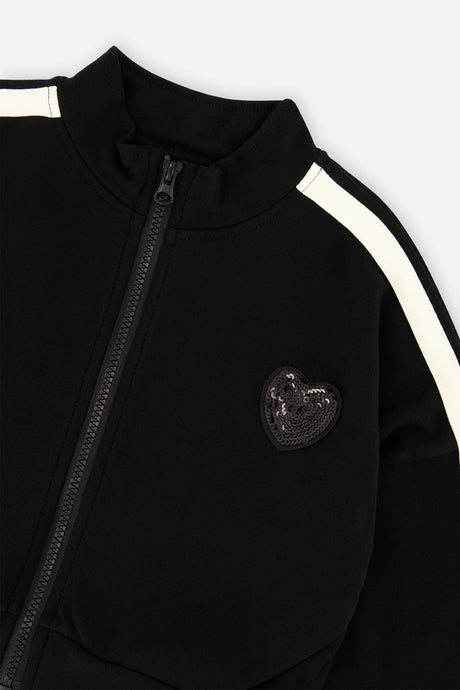 Close-up of the tonal sequin heart and stand-up collar on the black Milano jacket
