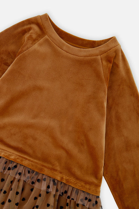 Close-up of the velvet raglan sleeve and dotted mesh skirt edge on the Deux par Deux caramel dress