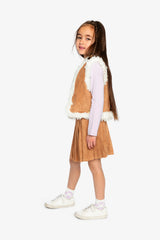 Child wearing the Deux par Deux reversible vest with the brown side out