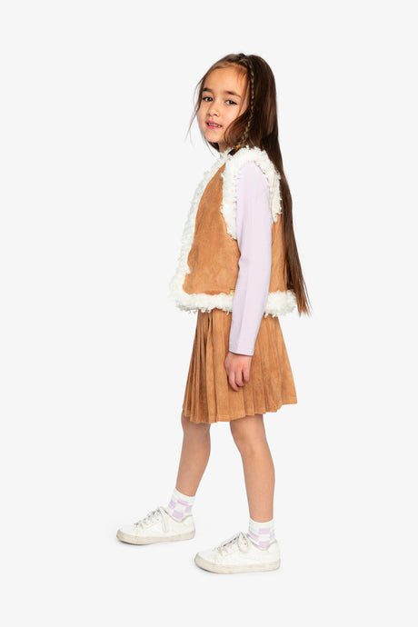 Child wearing the Deux par Deux reversible vest with the brown side out