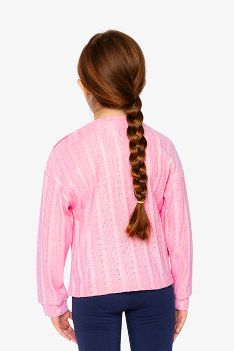 Child wearing the pink knit top, back view with a long braid
