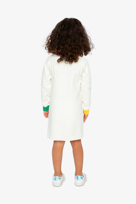 Child wearing the off-white heart knitted dress, back view with green and yellow cuffs