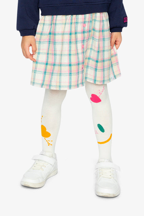 Child wearing the off-white Deux par Deux knit tights with a pastel plaid skirt and white sneakers