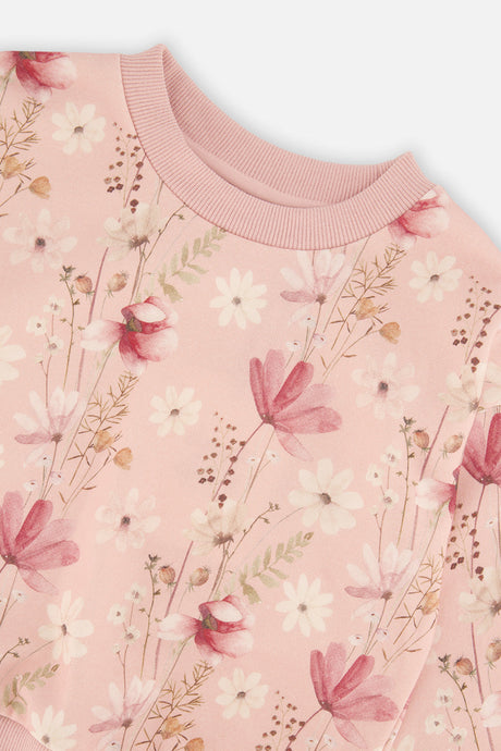 Close-up of the ribbed neckline and the rose pink and white wildflowers on the blush pink Deux par Deux sweatshirt