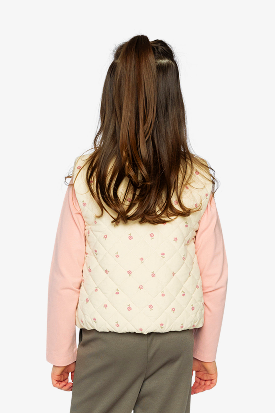Child wearing the cream floral quilted Deux par Deux vest, back view